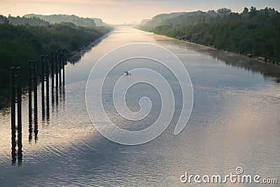 The photo shows a canoeist on the WisÅ‚a River. Stock Photo
